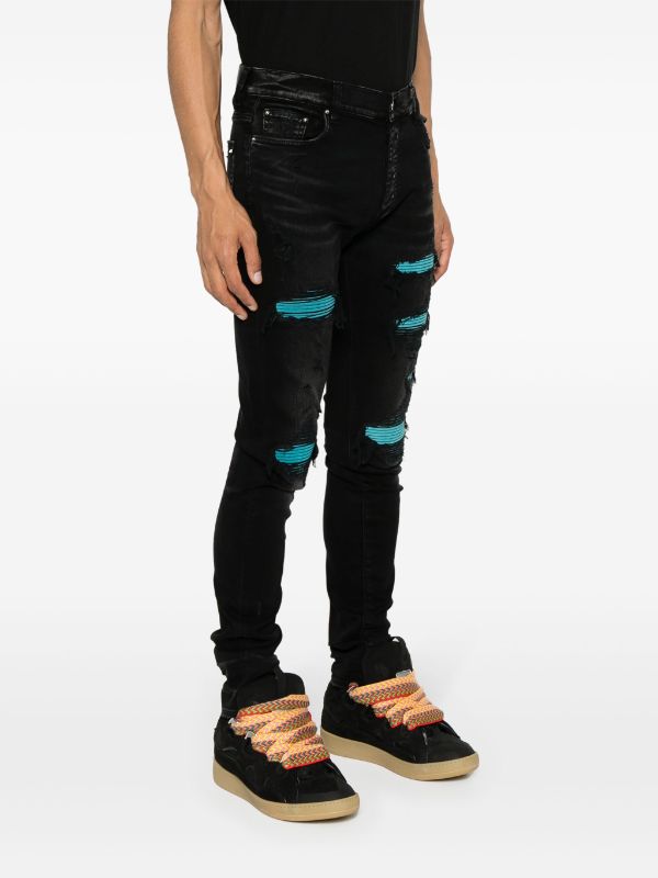 AMIRI (Skinny-Jeans mit Wildleder-Verzierung)