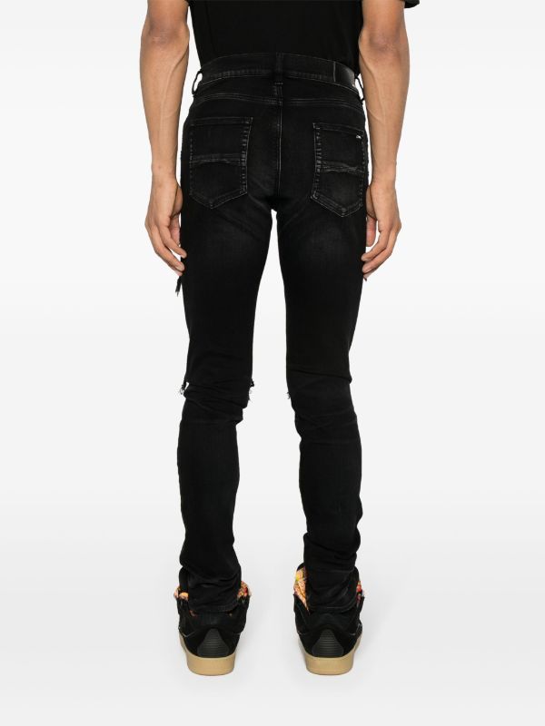 AMIRI (Skinny-Jeans mit Wildleder-Verzierung)